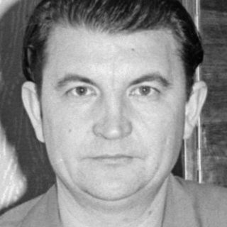 Upside-down portrait of a man in a button-down shirt.