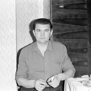 Upside-down portrait of a man in a button-down shirt.