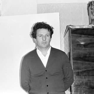 Portrait of a man in a suit, oriented vertically.